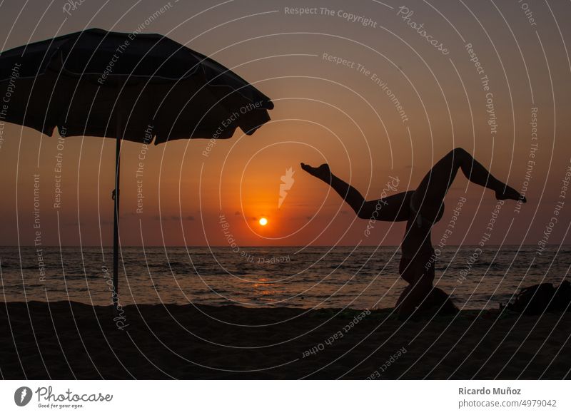 Yoga girl at sunset yoga girls Silhouette beach yoga sports Sunlight Beach life vacations Woman's body outdoors umbrella Feminine Freedom Girl Exterior shot