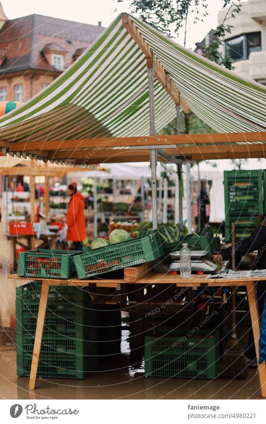 Market stall in the rain Rainy weather Bregenz Markets Market day rainy Marketplace stand sale crates Green Orange Autumn Wet Cold cold and damp Mitwetter