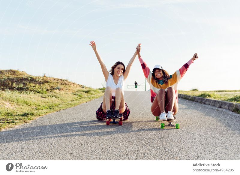 Beautiful skaters practicing riding skate board on street woman skateboard fun beautiful young trendy stylish youth skateboarder lifestyle girl summer female