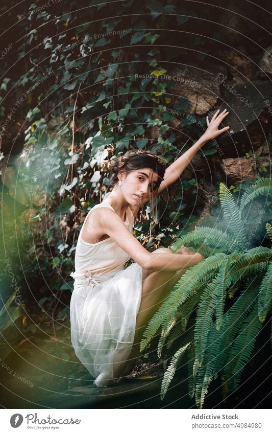 Young ballerina posing in a garden ballet young woman green female passe dance girl beauty person dress caucasian pose dancer elegance swan portrait art plants