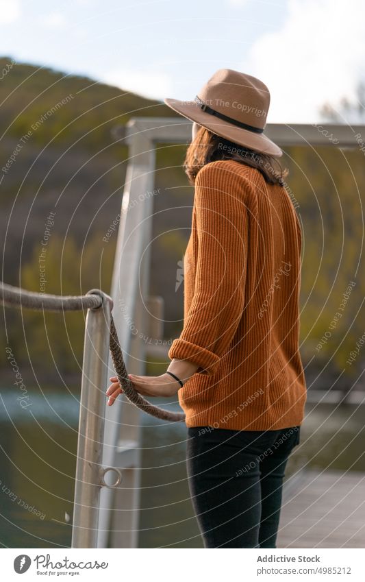 Peaceful woman on pier near lake admire traveler mountain pond quay observe female palencia spain adventure nature peaceful water serene tranquil harmony calm