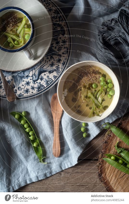 Bowl of creamy coconut soup with pea served raw traditional eating food natural diet wood dinner composition bowl vitality dish green vegan cuisine vegetarian