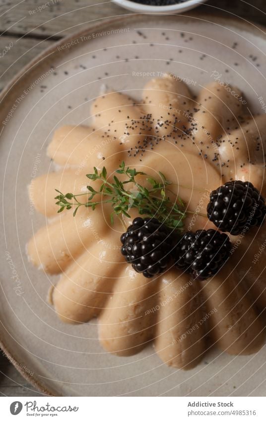 Closeup of creamy panna cotta with berries sweet served vegan peach tender blackberry poppy seeds gourmet delicate dessert layout table soft vegetarian