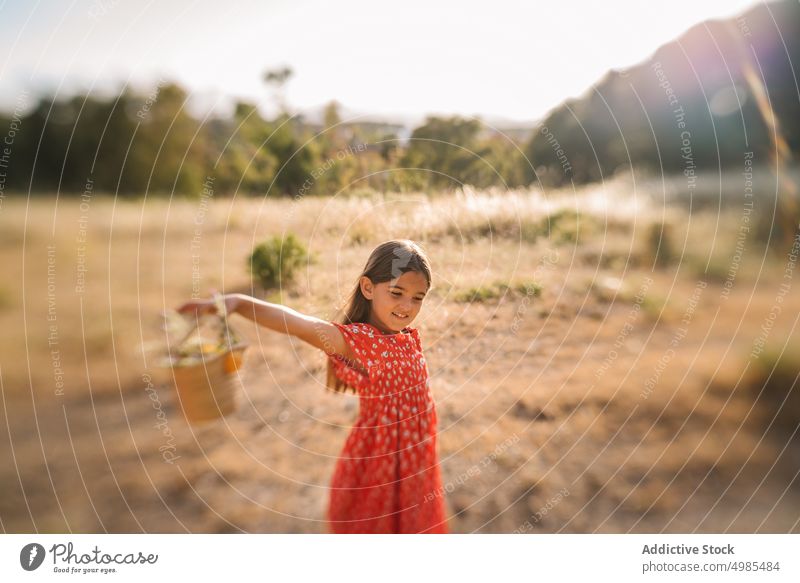 Little girl walking in field on sunny day run summer nature basket excitement flower collect energy childhood adorable holiday natural lifestyle pick beauty