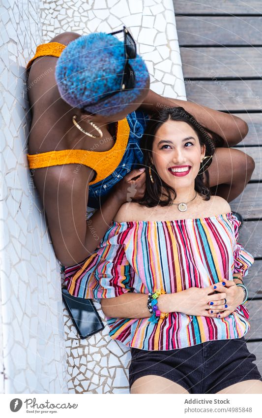 Diverse lesbian couple resting on bench park relax together love lgbt multiracial women young lifestyle leisure diverse multi ethnic african american asian joy