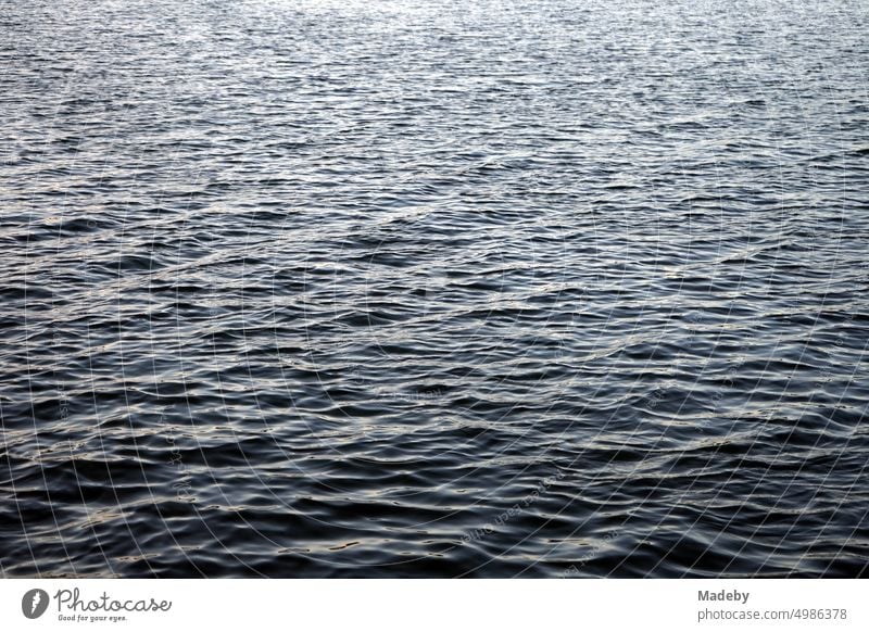 Dark and mysterious shimmering water surface with light swell of Poyrazlar Gölü near Adapazari in summer sunshine in Sakarya province, Turkey peril depth Water