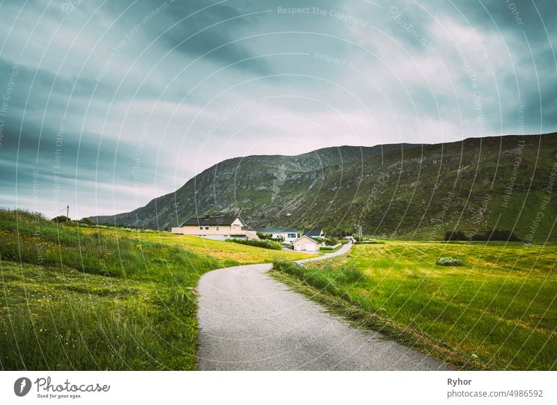 Alnesgard, Godoya, Norway. Road In Alnesgard, Godoya. Old Houses In Summer Day In Godoy Island Near Alesund Town More Og Romsdal Norwegian Nature alesund