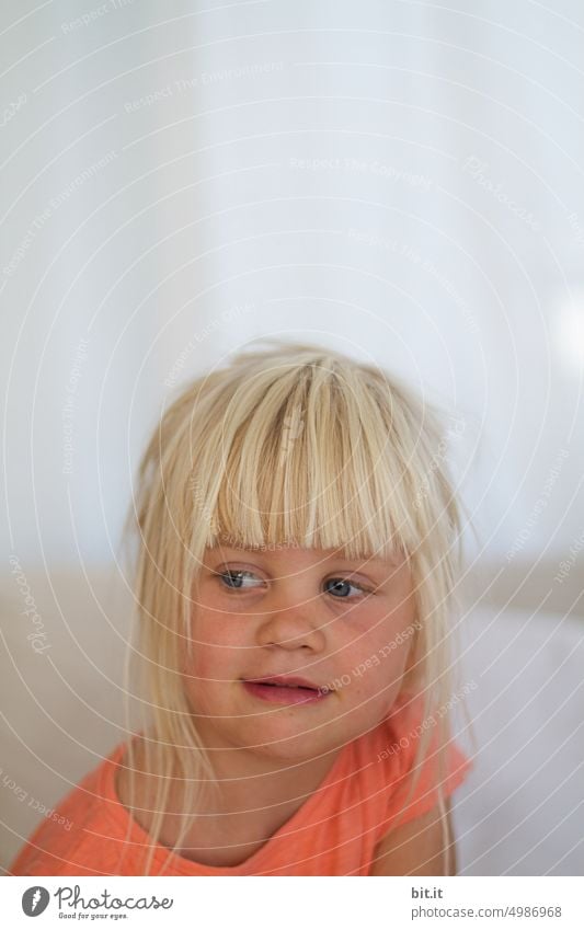 Natural blonde girl on bright neutral background, laughing into camera. Child, girl with bright eyes. Funny, witty portrait. Childhood, happiness, cheerfulness, humor. Beautiful childhood. Child, teeth, mouth. Cheeky, mischievous joker.