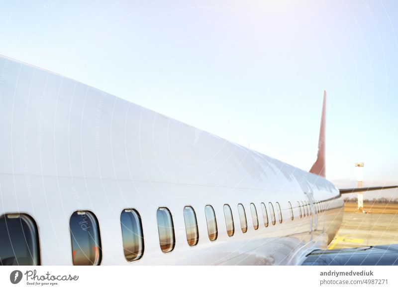 Airplane being preparing ready for takeoff in international airport at sunset - Travel around the world. High quality photo airline airplane arrival boarding