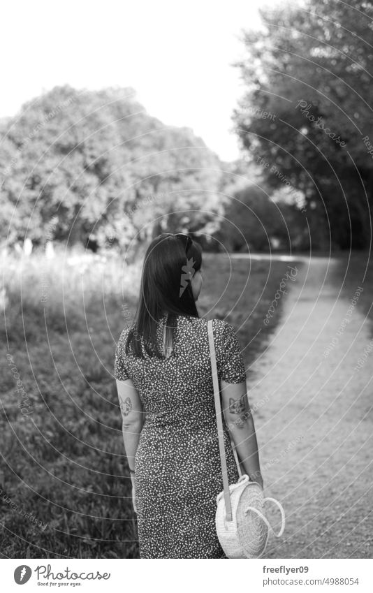 Woman walking by a path through the forest woman from behind grayscale black and white hiking girl wood nature trail open faith outside tree breath living hair