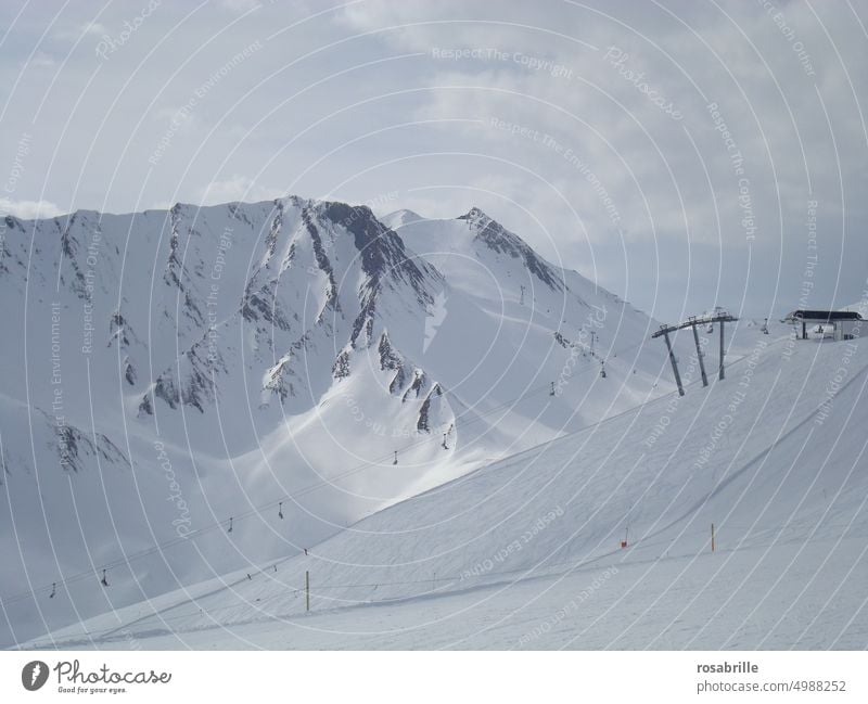 Winter landscape with high mountains in ski resort with chairlift Snow Cold snowed in cloudy Freeze freezing cold chill Wintertime winter snowy Landscape Hill