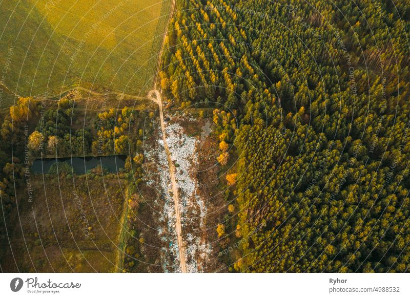 Aerial View Of Domestic Garbage Near Green Forest. Bird's-eye View Of Junk. Domestic Waste In Landfill Junkyard. Eco Concept Garbage Disaster From Ecological Pollution Of Environment