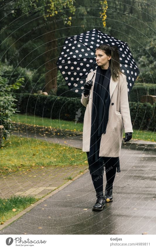 [HH Unnamed Road] Young woman with umbrella walking along a path Woman walking woman Umbrella Lanes & trails Cemetery Ohlsdorf Cemetery Hamburg naturally bushes