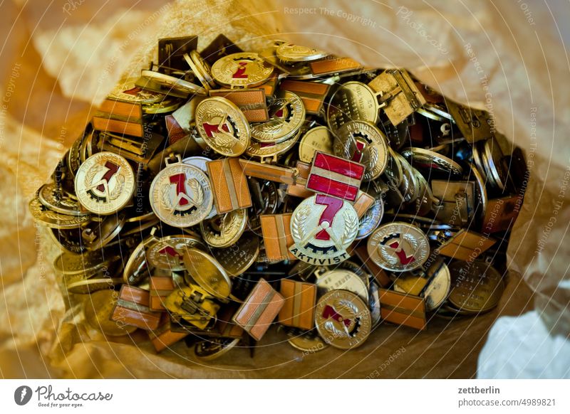 Looking into a bag full of activist badges Activist Old Ancient award insignia Brigade GDR Museum Order Working class museum quantity mass a lot variety