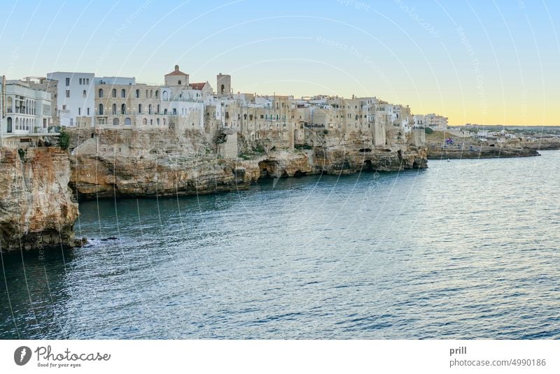 Impression of Polignano a Mare in Apulia in Italy at evening time apulia Bari adriatic sea ocean sundown sunset waterfront Mediterranean town rock formation