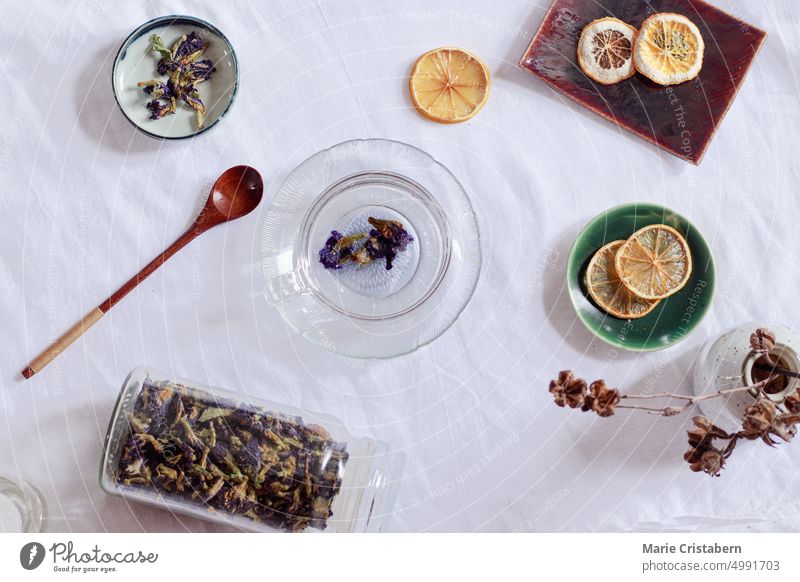 Overhead view of dried butterfly pea flowers or Clitoria ternatea and dried lemon slices for making a healthy and healing herbal tea Wellbeing Summer Bright