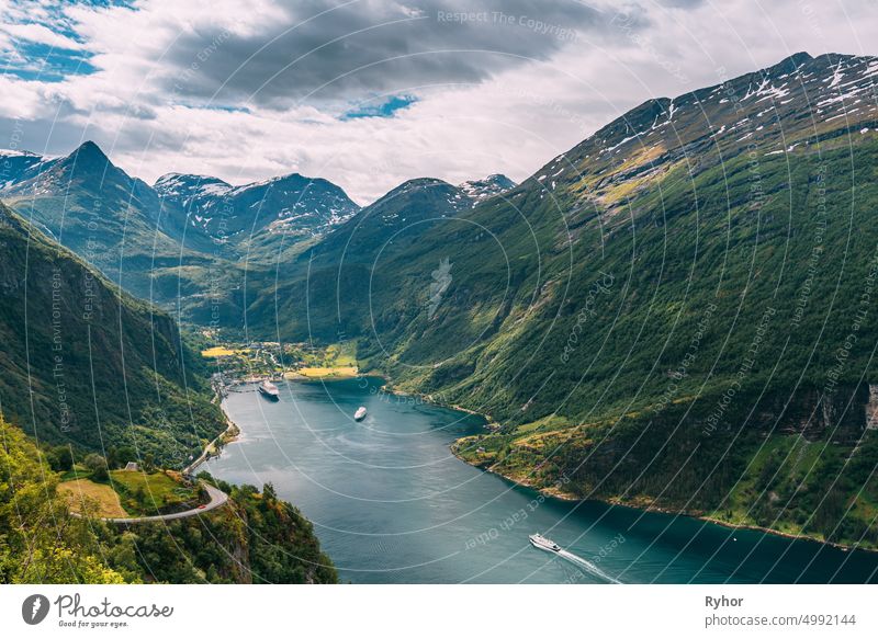 Geirangerfjord, Norway. Touristic Ship Ferry Boat Cruise Ship Liner Floating Near Geiranger In Geirangerfjorden In Sunny Summer Day. Famous Norwegian Landmark And Popular Destination