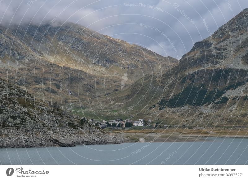 At the Lago di Montespluga Slügenpass mountain lake Lake pass road Alpine Storm somber Bright spot Sky Watershed Alps Mountain Landscape Vacation & Travel