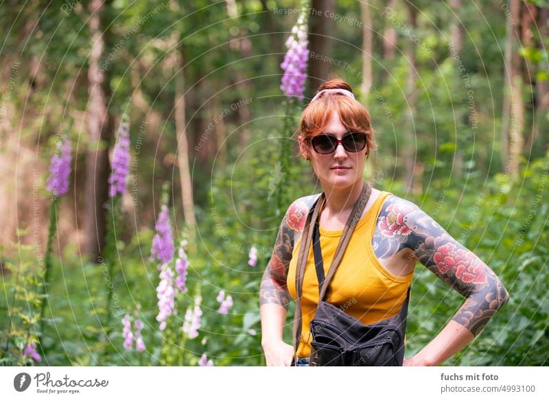 Young woman with asian tattoo in front of colorful plants Tattoo Asia sleeve flowers Garden Woman youthful pretty portrait Girl Nature Beauty & Beauty Cute