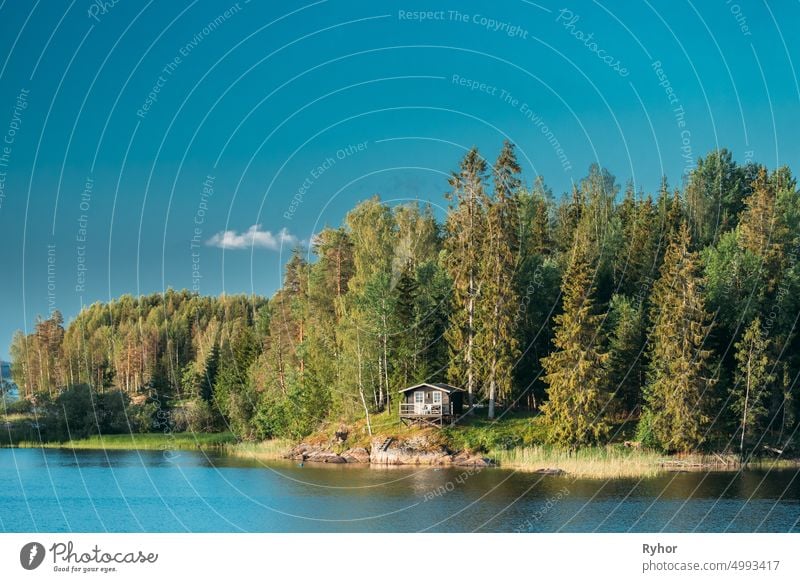 Sweden. Beautiful Swedish Wooden Log Cabin House On Rocky Island Coast In Summer Sunny Evening. Lake Or River Landscape apartment architecture bathhouse