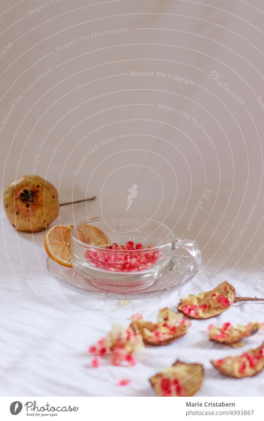 Vertical shot of pomegranate seeds on a glass cup to make fresh fruit juice for a refreshing summer drink Summer Pomegranate Refreshment Wellbeing