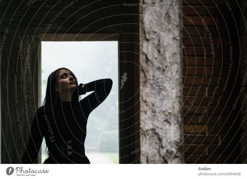 [HH Unnamed Road] Young woman with hopeful upturned gaze inside a memorial Hope Light Grief Loneliness Sky Nature Exterior shot Sadness Dark Death Transience