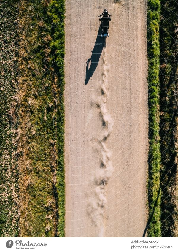 Unrecognizable motorcyclist riding bike on rural road ride countryside person drive motorbike vehicle transport travel adventure lifestyle freedom speed motion