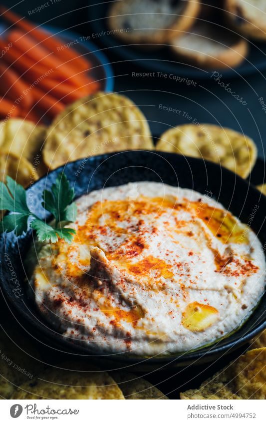 Homemade hummus ready to serve appetizer bowl bread carrot chickpea creamy dip food healthy homemade Hummus lunch oil olive oil paprika parsley snack tahini