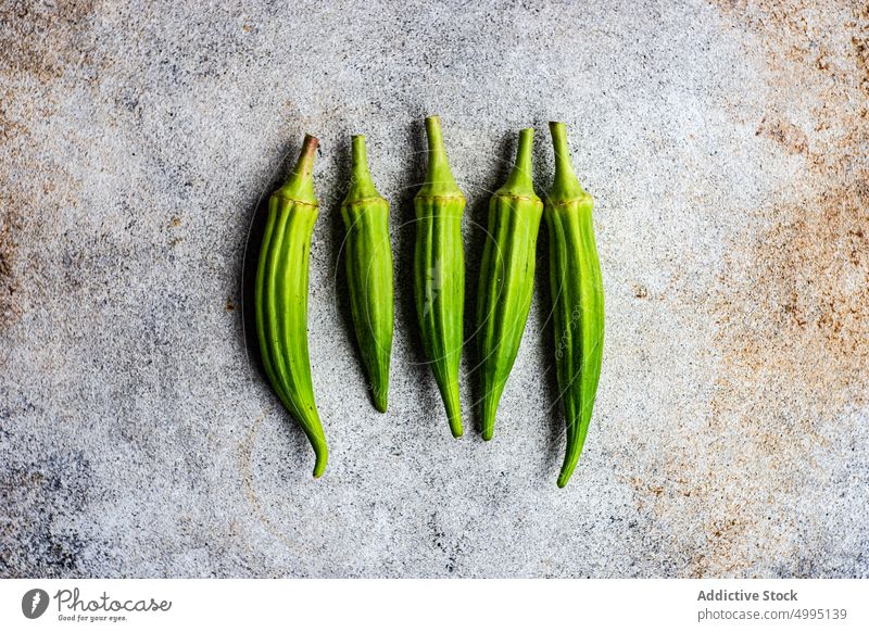 Raw bamia in concrete background bamya cook cooking cuisine food green healthy okra organic raw table vegan tray vegetable vegetarian Ketogenic keto diet