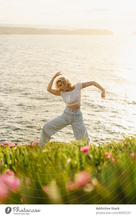 Woman dancing near sea at sunset woman dance shore dancer perform summer weekend water aviles asturias spain female romantic coast sundown skill seaside