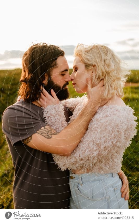 Couple hugging against sundown sky couple sunset countryside love date kiss tender romantic together aviles asturias spain relationship affection embrace