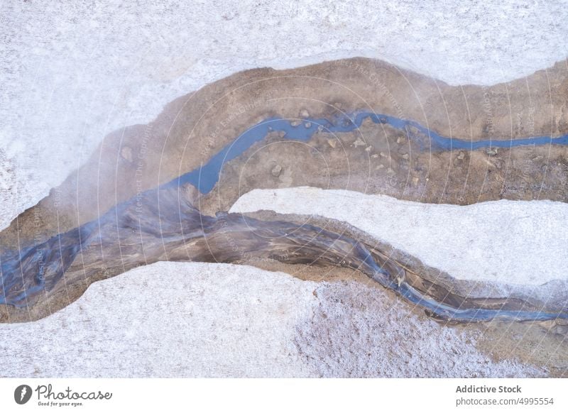 Thin hot streams near snow steam winter terrain rough ground geothermal area reykjahlid iceland hverir flow water volcanic brook untouched formation nature