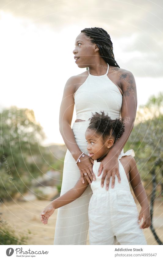 Black mom and daughter admiring countryside mother admire together sunset summer love touch weekend woman girl cloudy sundown child parent black