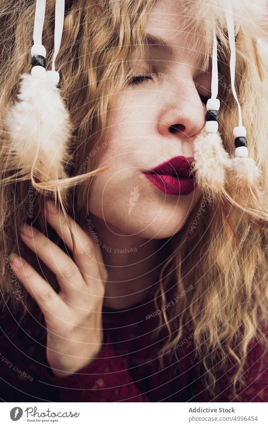 Woman with dream catcher in studio woman serene dreamy decorative feather blond peaceful eyes closed female style charming fantasy dress tender calm gentle show