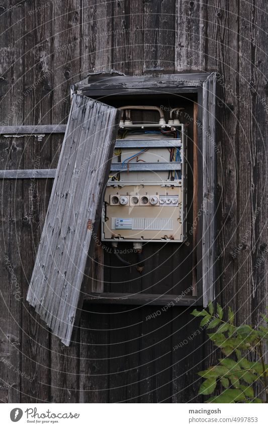 Old, defective fuse box Backup Fuse-box Exterior shot Deserted nobody Wood Broken broken power supply Colour photo Energy industry Technology stream