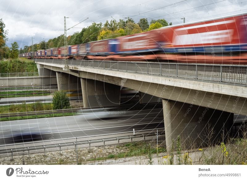 Railway crossing a highway Autobahn Autumn Bridge Building Car Cargo Carrier Commute Concrete Driving Environment Europe Fall Freeway Freight Freight Train