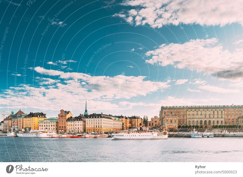 Stockholm, Sweden. Touristic Boat Floating Near Famous Embankment In Old Town Gamla Stan In Summer Evening. Famous Popular Destination Scenic Place And UNESCO World Heritage Site