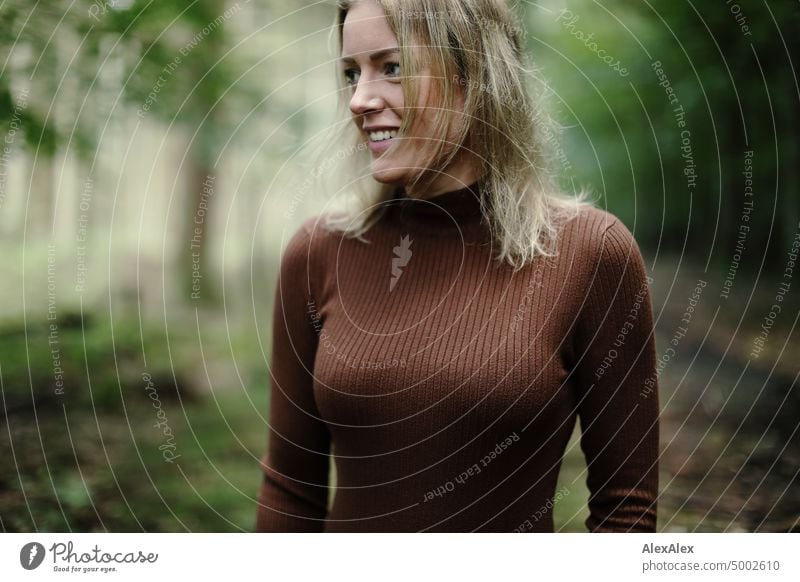 Young blonde woman standing in forest smiling happily to camera Young woman Woman Blonde Feminine pretty fortunate Youth (Young adults) portrait Adults