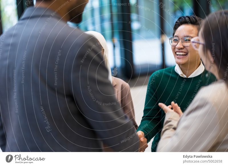 Multi-ethnic business group in an office building Multiracial Group team diversity teamwork muslim real people young adult student positive smiling cheerful