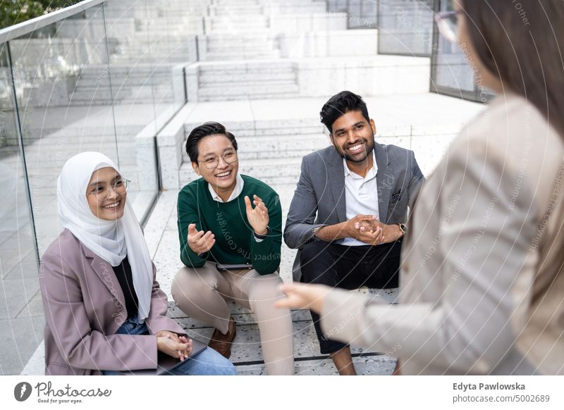 Multi-ethnic group of young business people outdoors in the city Multiracial Group team diversity teamwork muslim office real people adult student positive