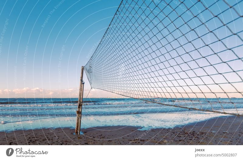 Beach volleyball net directly on the beach with sea in the evening atmosphere Ocean Beautiful weather Waves Beach Volleyball Wind Sky Clouds Infinity Deserted