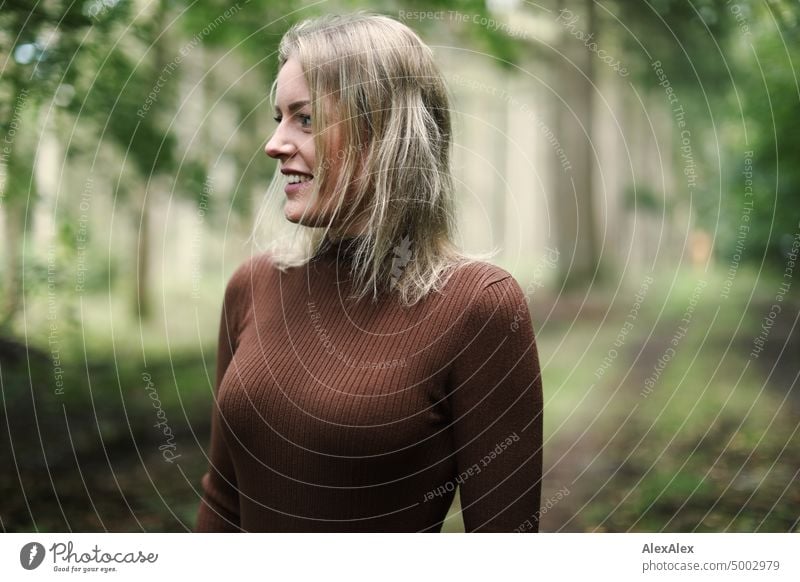 Young blonde woman standing in forest smiling happily to camera Young woman Woman Blonde Feminine pretty fortunate Youth (Young adults) portrait Adults