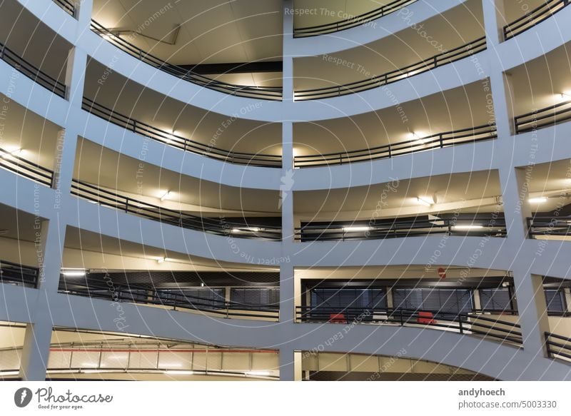 The illuminated driveway of a multi-storey car park architecture automobile automotive Background building Business cement city concrete construction corridor