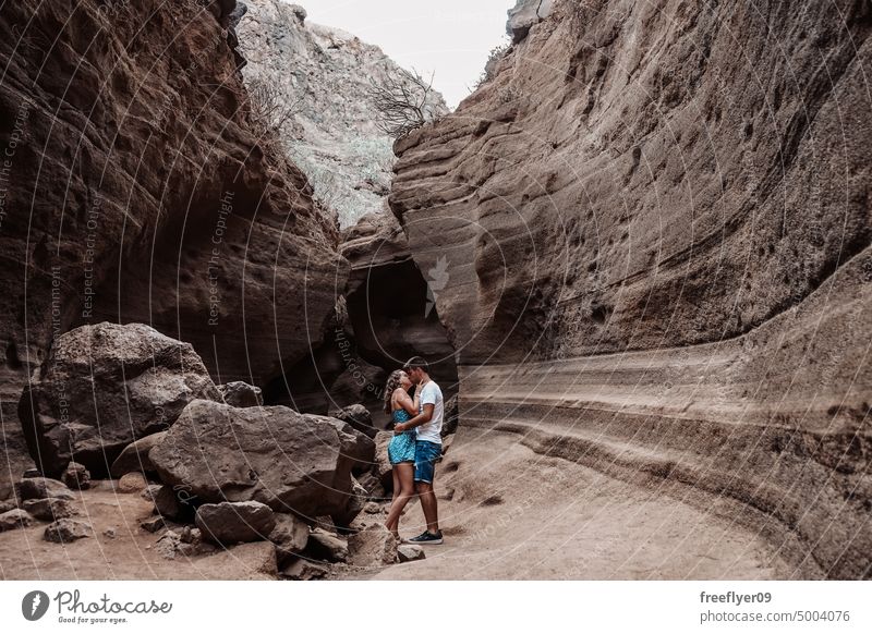 Young couple on their honeymoon young heterosexual woman blue barranco vacas cave volcanic spain copy space geological travel geology erosion canyon nature