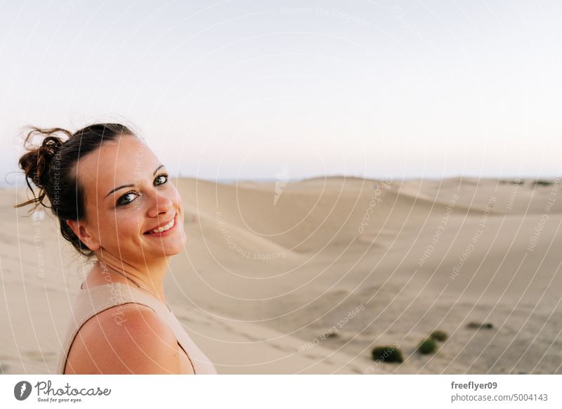 Tourist on the Maspalomas desert dune woman walking maspalomas sand Gran Canaria copy space Canary islands Spain tourist travel hiking outdoors hike sunset