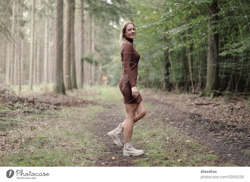 Young blonde woman walking on forest path and looking sideways at camera Young woman Woman Blonde Feminine pretty fortunate Youth (Young adults) portrait Adults