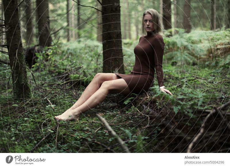 Young blonde woman sitting barefoot on fallen log in forest Young woman Woman Blonde Feminine pretty fortunate Youth (Young adults) portrait Adults naturally