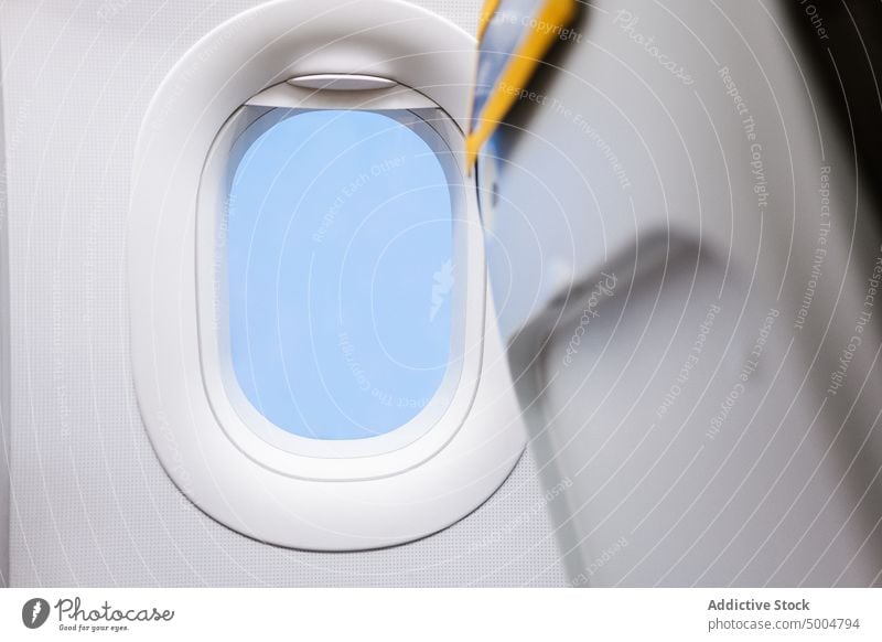 Windows of modern plane in daytime window sunlight illuminate white cabin interior aviation flight design contemporary transport glass bright daylight symmetry