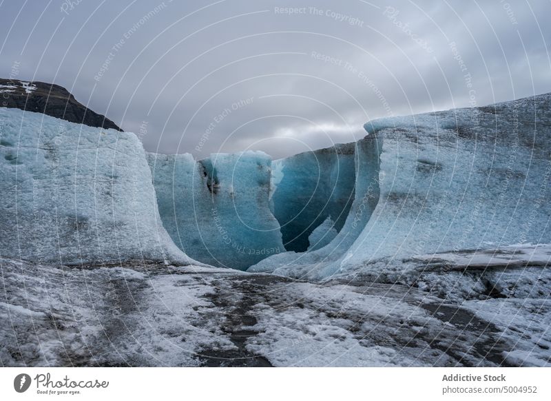 Icy cliffs against overcast sky formation ice winter cold cloudy gray glacier weather iceland vatnajokull national park nature frozen countryside landscape