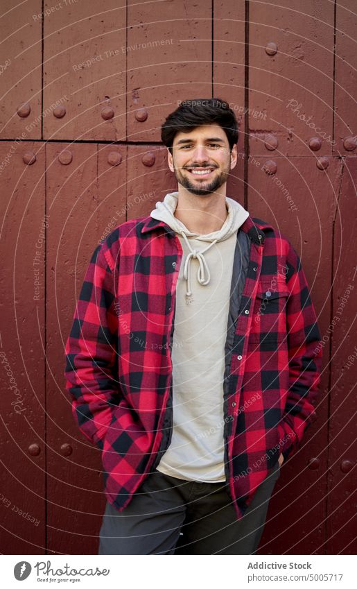 Cheerful man near old building travel tourist wall aged traveler wanderlust street smile cheerful beard male happy tourism glad positive optimist content enjoy